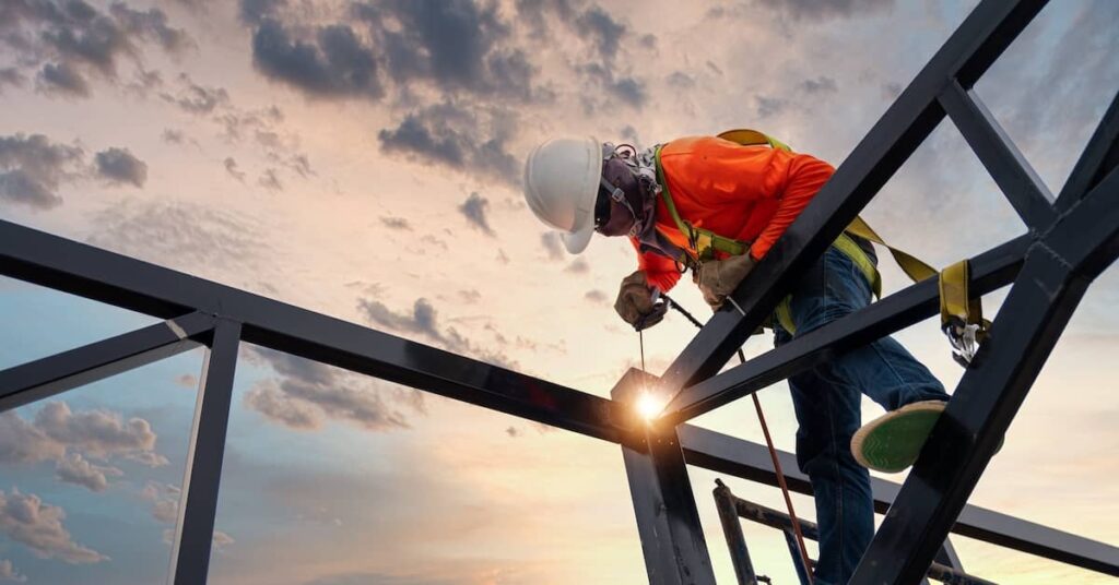 a construction worker welds on a beam | Oliver Law Firm construction accident lawyers